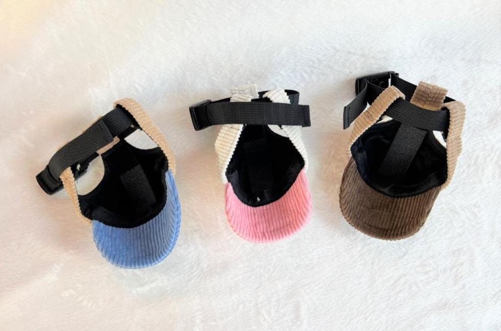 Three NKpup My Little Corduroy Caps for pets in blue, pink, and brown.