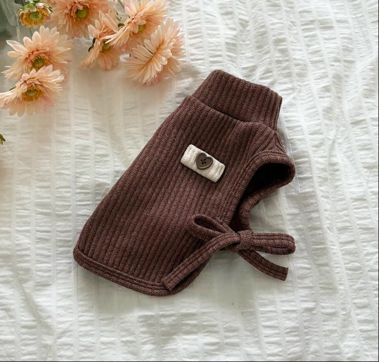 Brown ribbed dog turtleneck vest with a heart button detail and tie back.