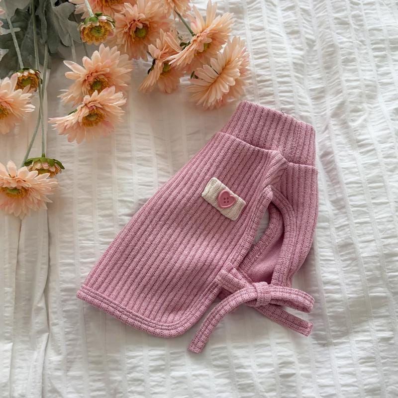 Pink ribbed dog turtleneck vest with heart detail and tie accents by NKpup