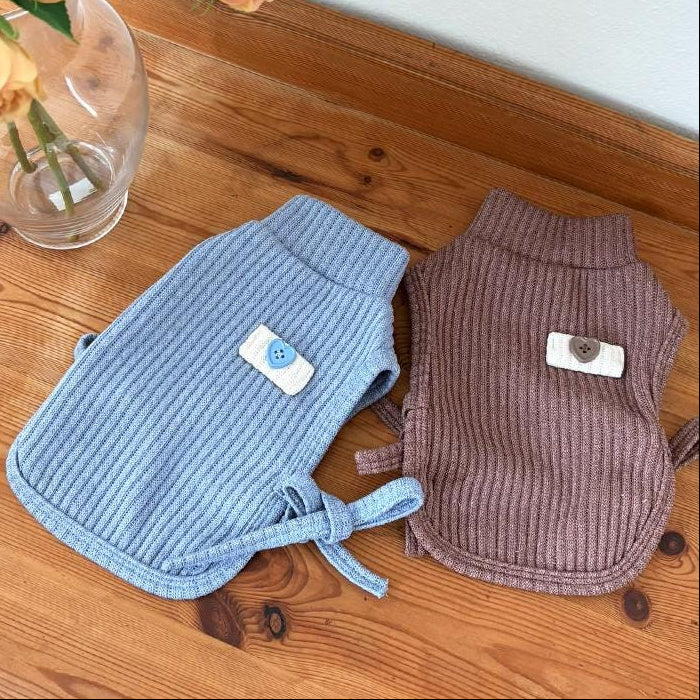 Blue and mauve ribbed dog turtleneck vests with decorative button accents.