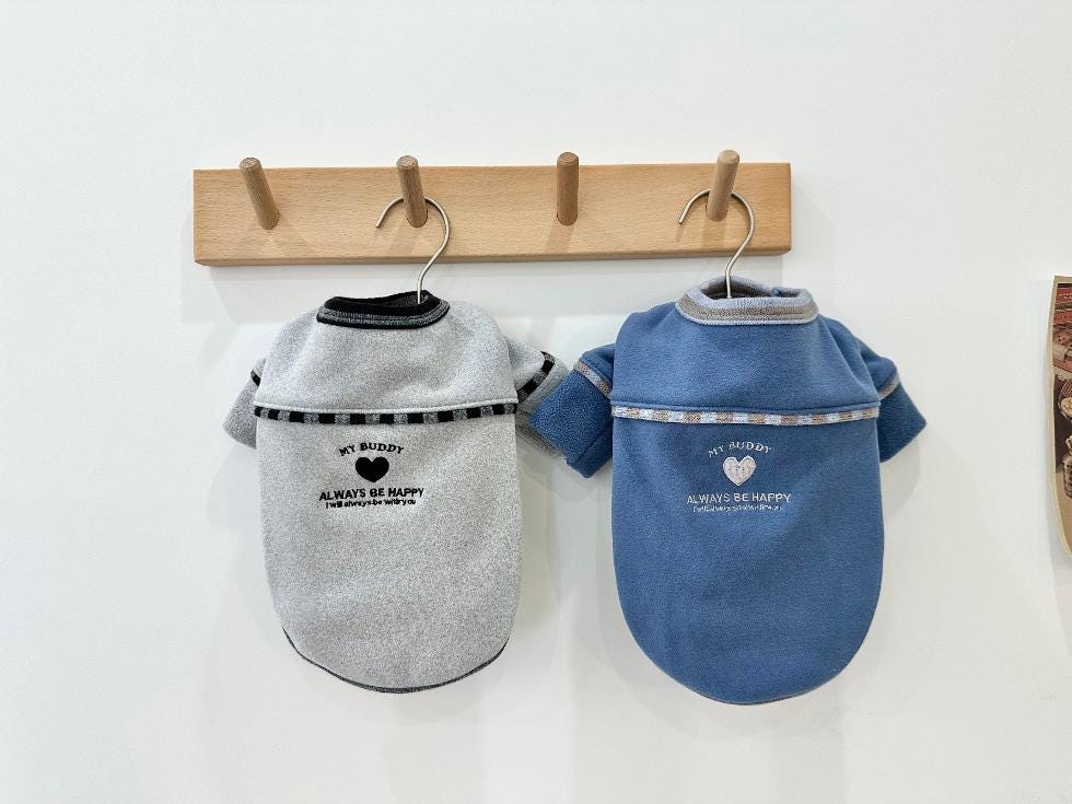 Two NKpup My Buddy fleece t-shirts for dogs in grey and blue with heart graphics.
