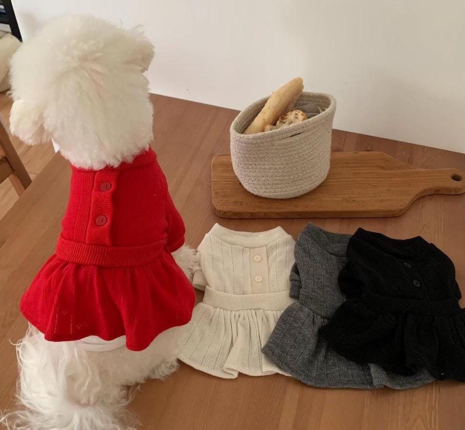 Chic knit peplum dog dresses in red, cream, grey, and black.