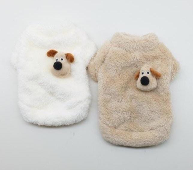 Two plush fleece dog sweaters in white and tan featuring cute cartoon dog face patches.