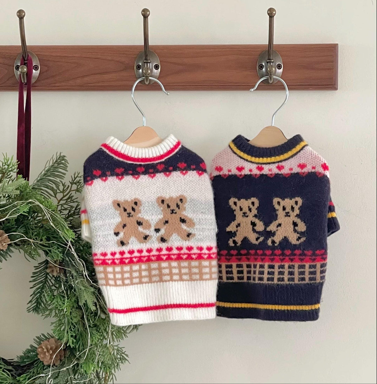 Two NKpup Christmas twin bear knit dog sweaters in white and navy with teddy bear patterns.
