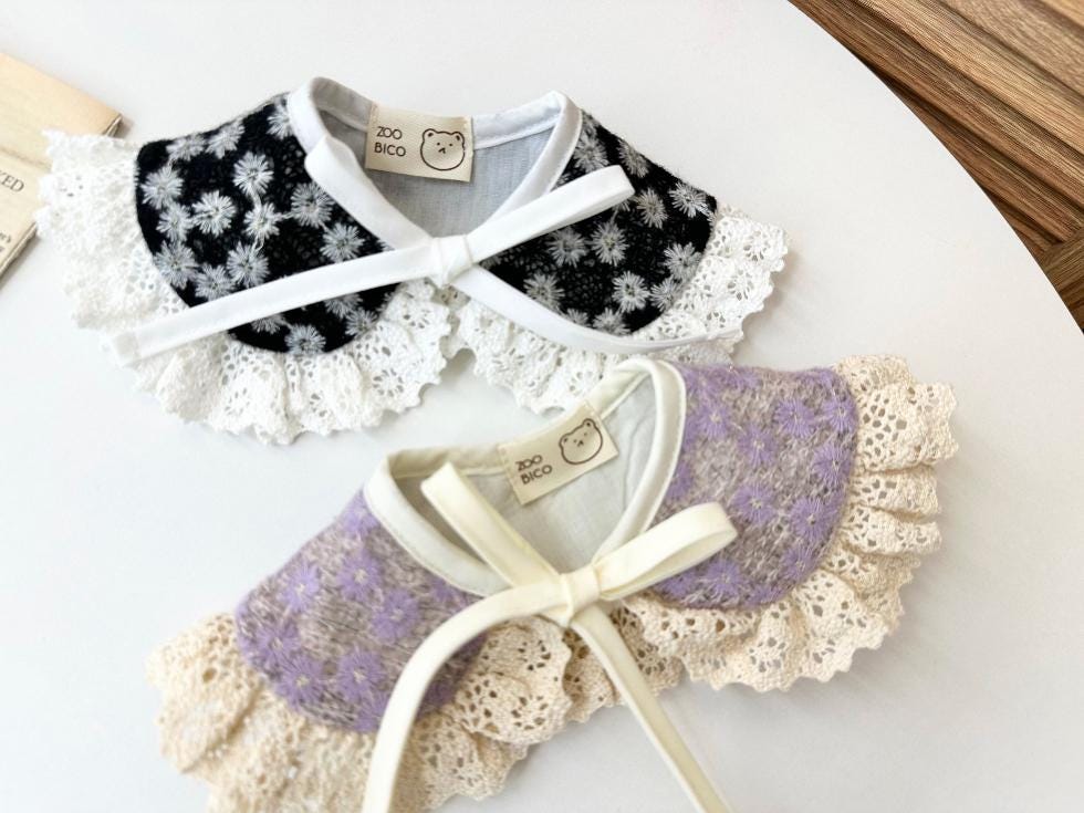 Black and lavender floral lace dog capes with white ribbon ties