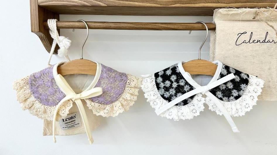 NKpup floral lace dog capes in lavender and black floral patterns with ruffled edges.