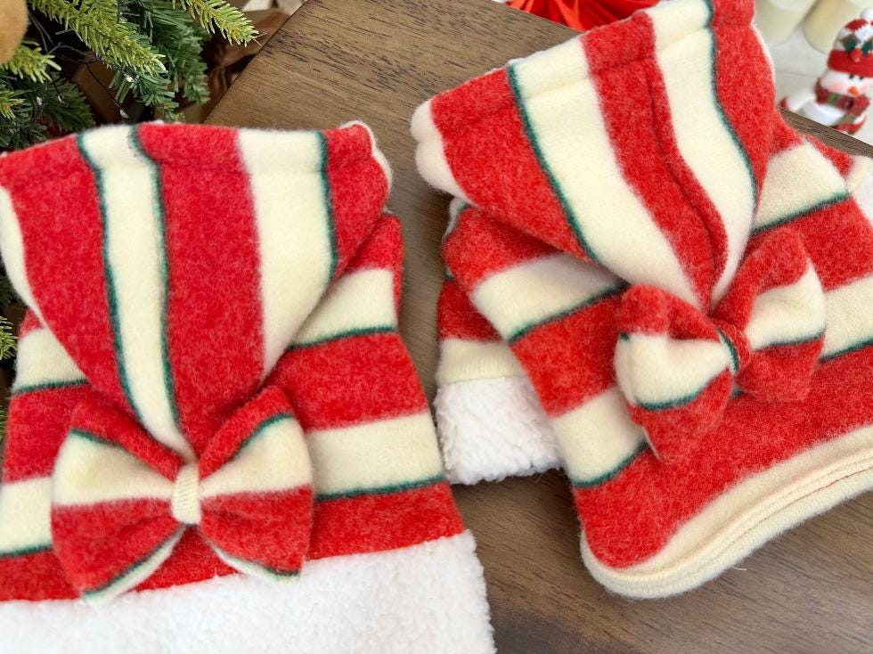Red and white striped Christmas bow dog shirt with white fleece trim