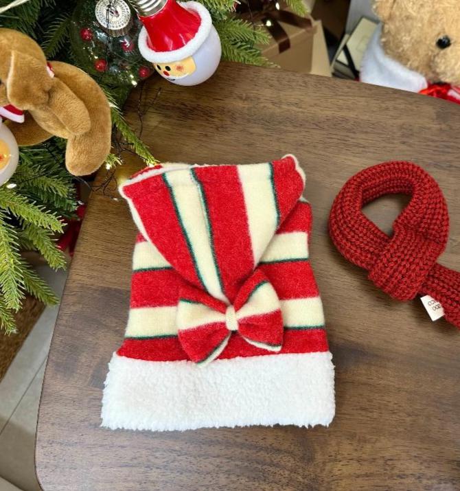 Red and white striped Christmas bow dog shirt with a white fuzzy trim.