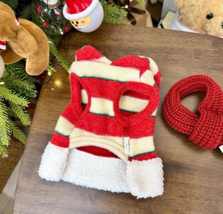 Red and white striped Christmas dog shirt with a fuzzy white trim.