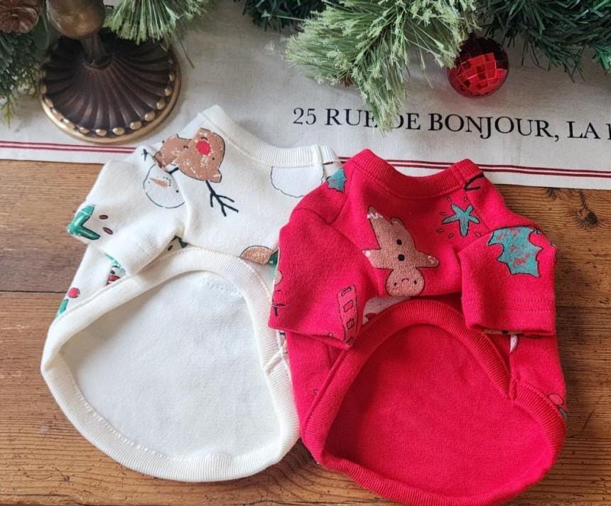NKpup Christmas D-Ring dog shirts in white with gingerbread man and red with festive holiday patterns.