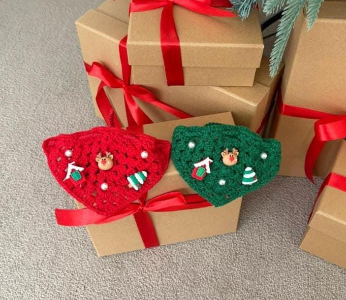 Red and green crochet Christmas dog cape and hat set with festive holiday ornaments.