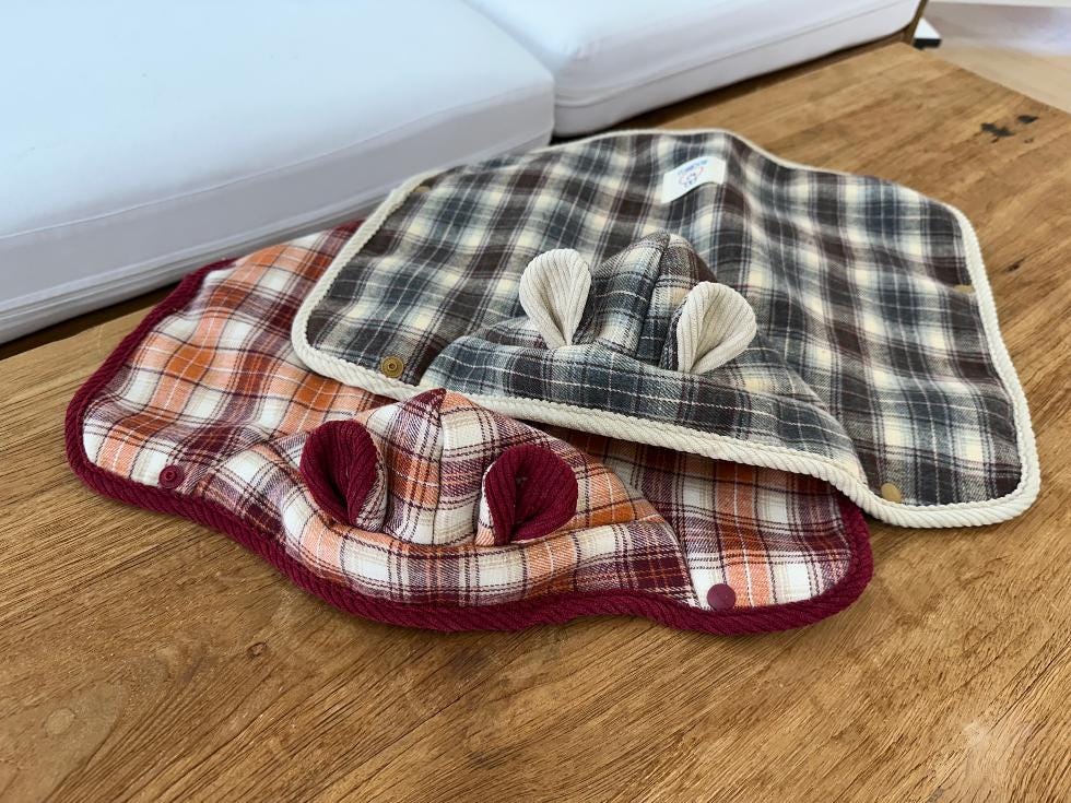 NKpup plaid cape dog vests in brown and orange checkered patterns with decorative ears.