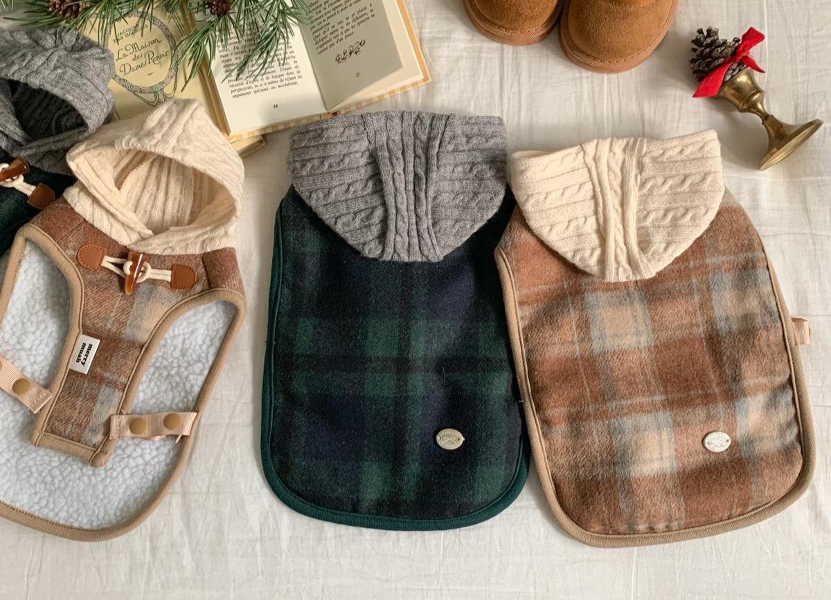 Three plaid poncho dog coats in brown, green, and tan with knitted hoods.