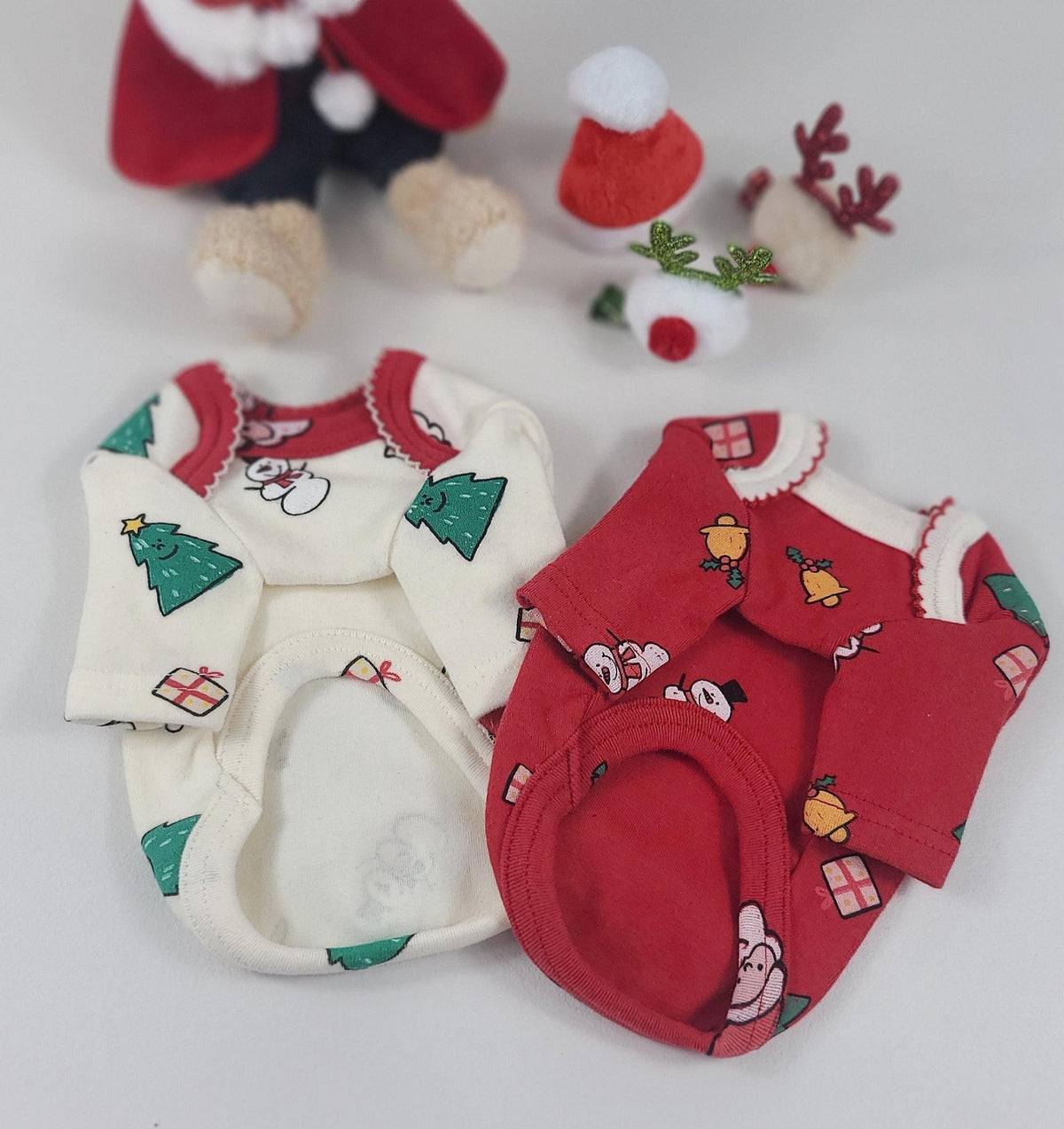 Christmas Santa dog shirts in white with green trees and red with festive bells pattern.