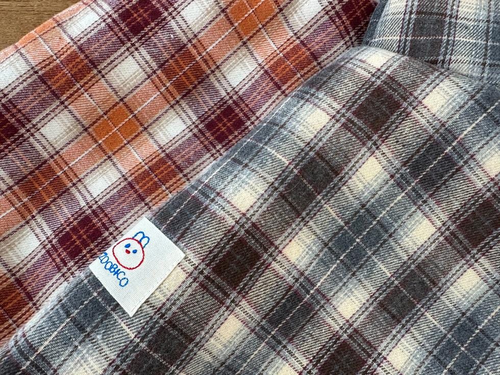 Plaid cape dog vest in orange and grey checkered patterns by NKpup