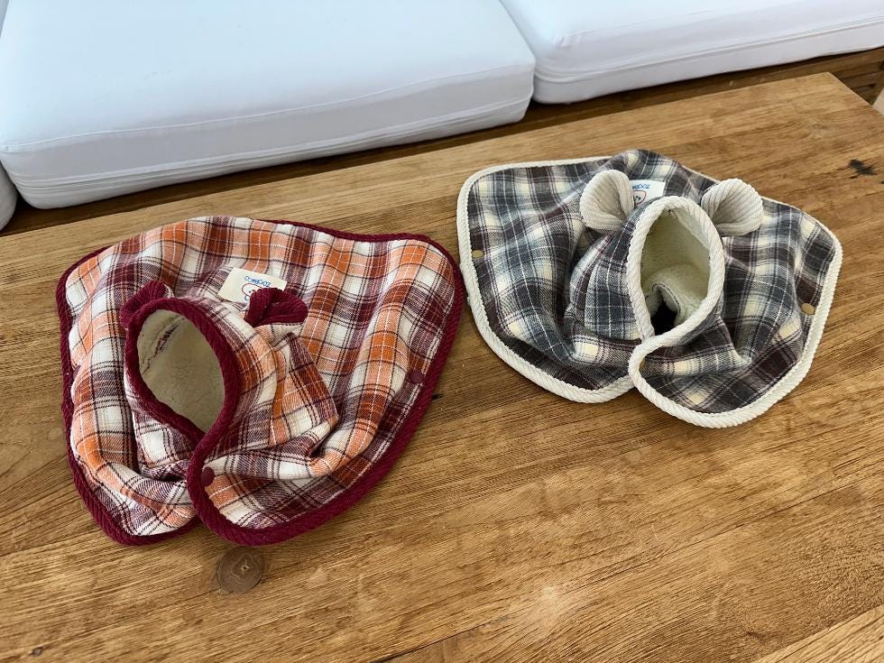 NKpup plaid cape dog vests in orange and grey checkered patterns with soft fleece lining.