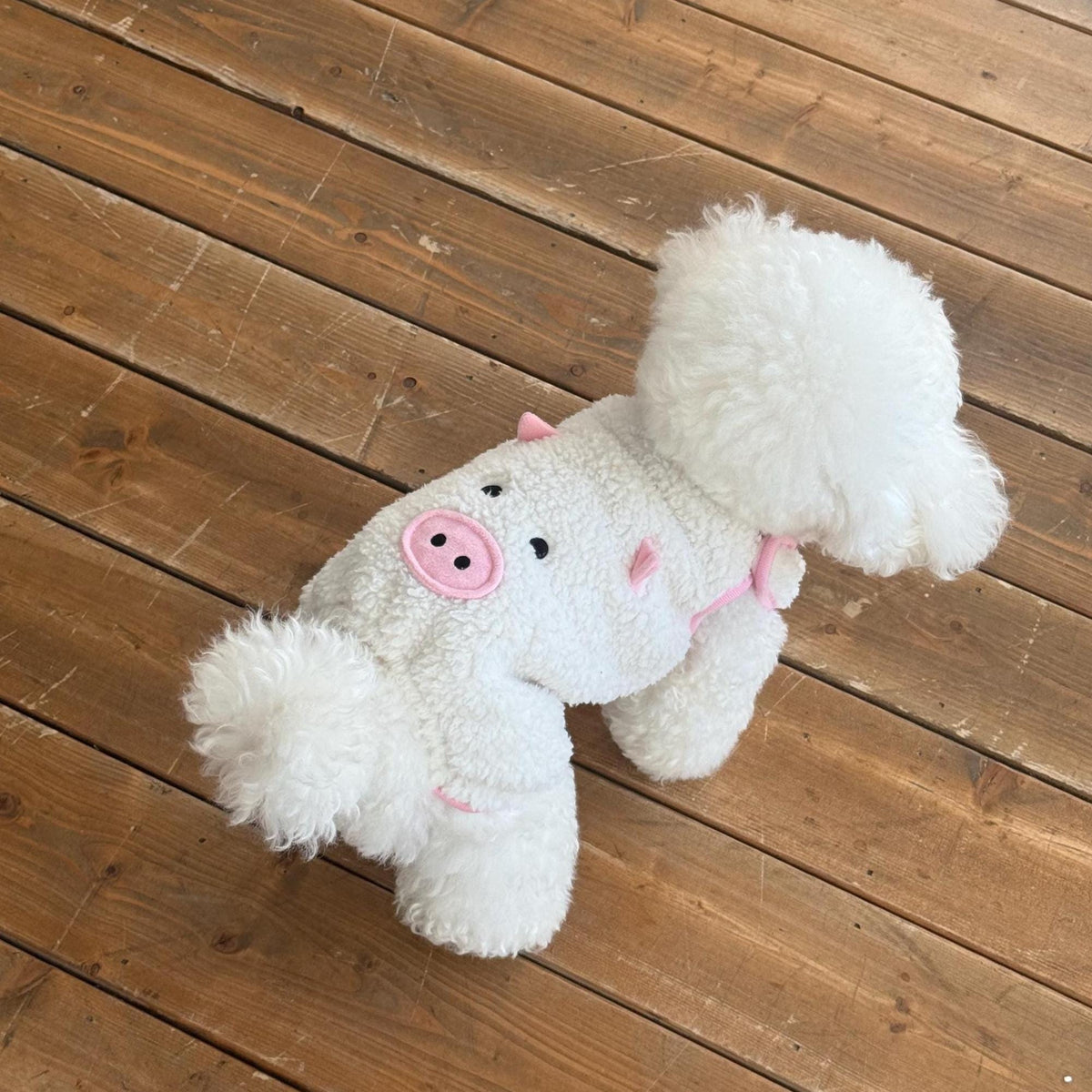 Plush white fleece dog overall with a pink pig face design