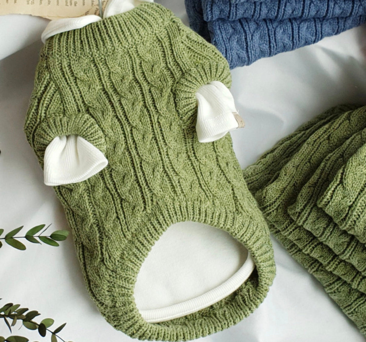 Green cable knit dog vest with white ear details