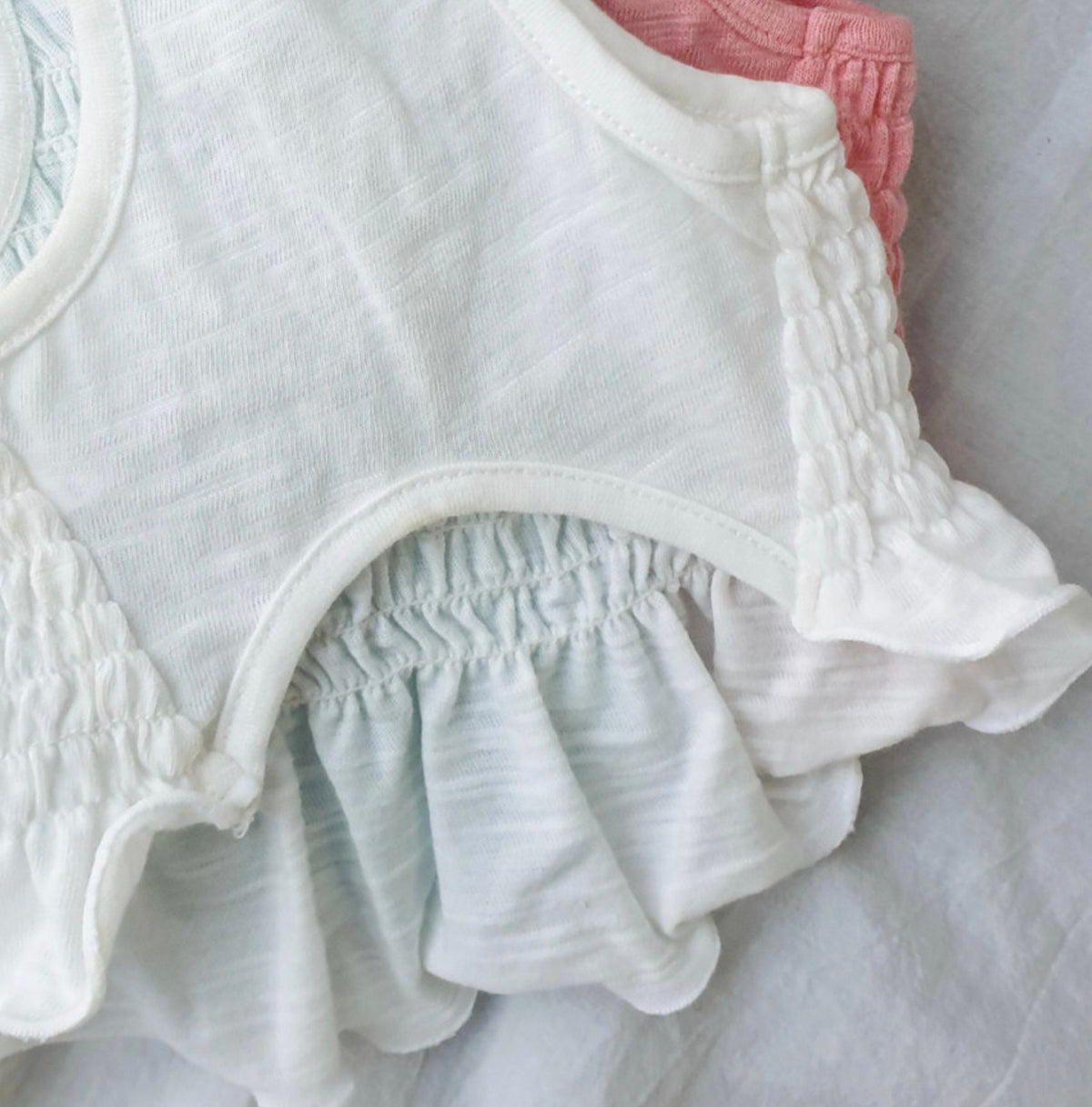 Solid smocked dog crop top in white and light blue with ruffled details by NKpup