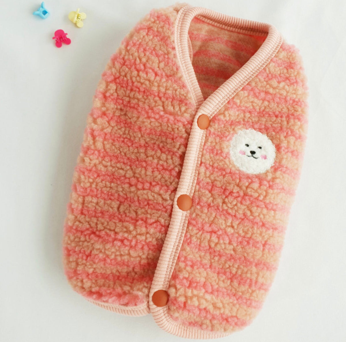 NKpup stripe fleece dog vest in peach and orange with a cute dog face patch