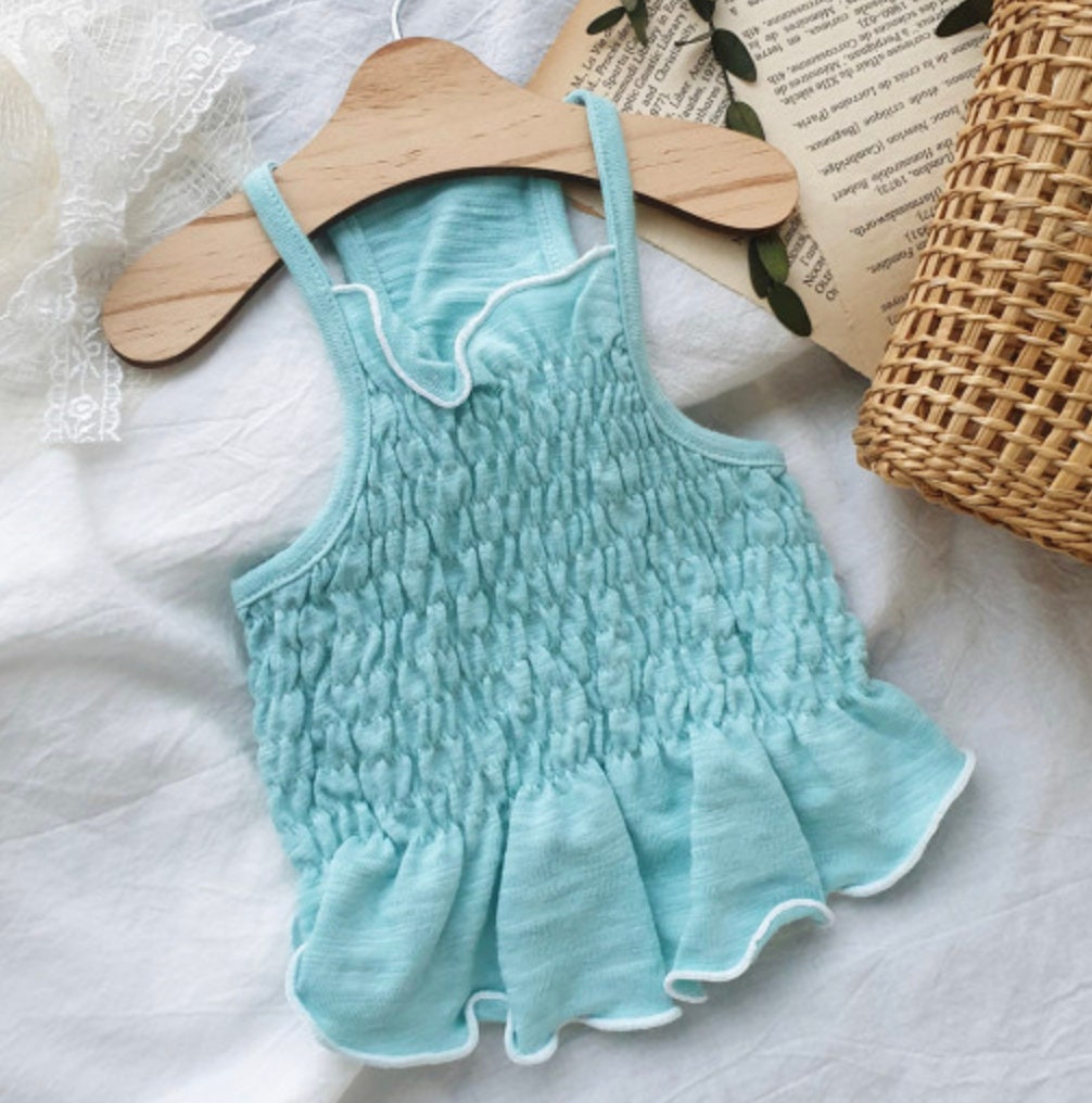 Solid smocked dog crop top in light blue with ruffled hem