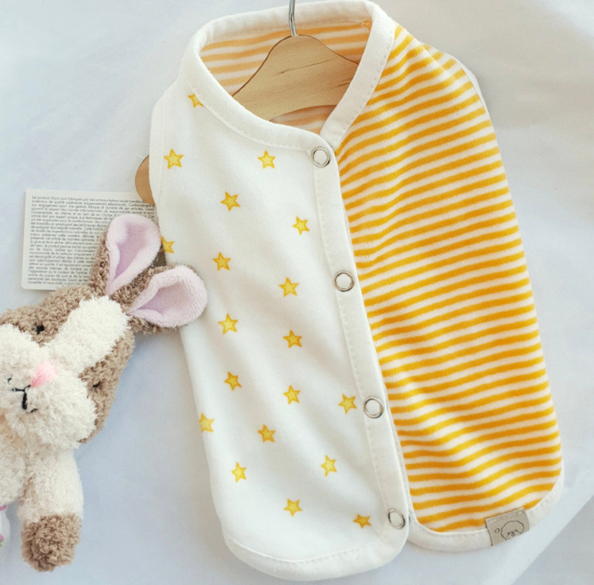 NKpup Velour Star Dog Vest featuring white fabric with yellow stars and yellow stripes.