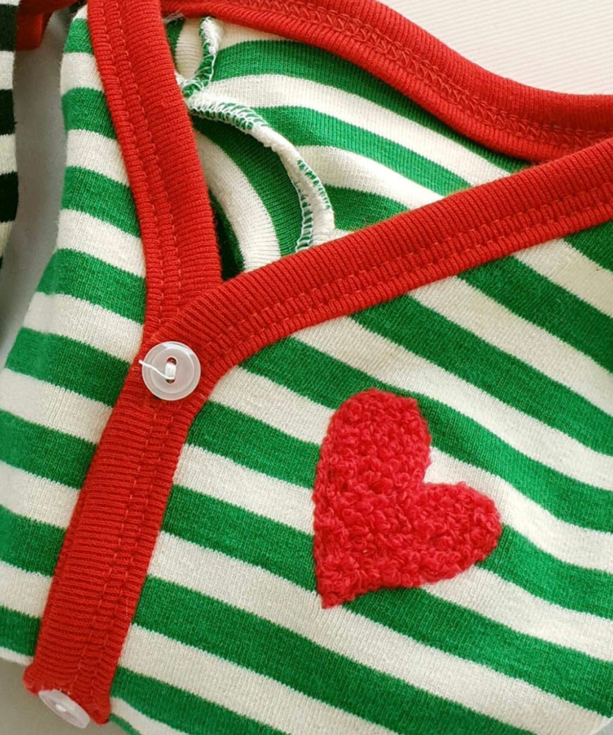 NKpup Heart Stripe Dog Cardigan in green and white with a red heart patch and red trim.