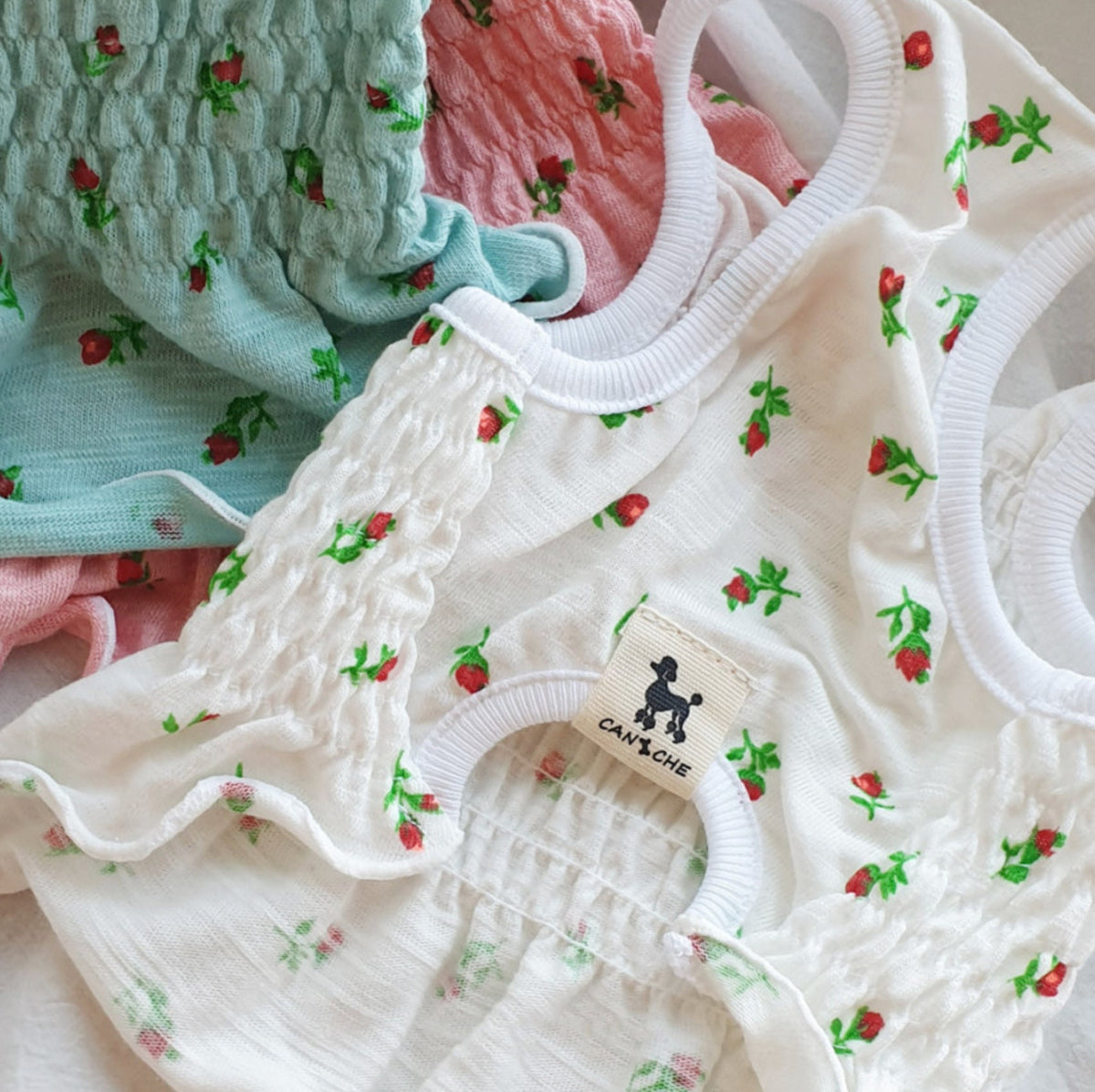 Rose smocked dog crop top in white, light blue, and pink floral patterns.