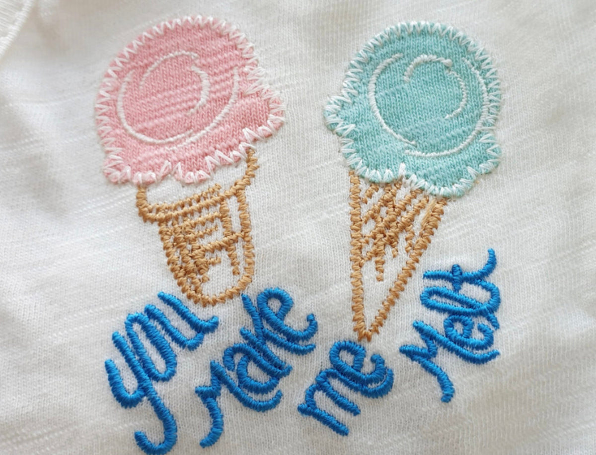 White NKpup dog crop tank top featuring embroidered pink and blue ice cream cones with 'you make me melt' text.