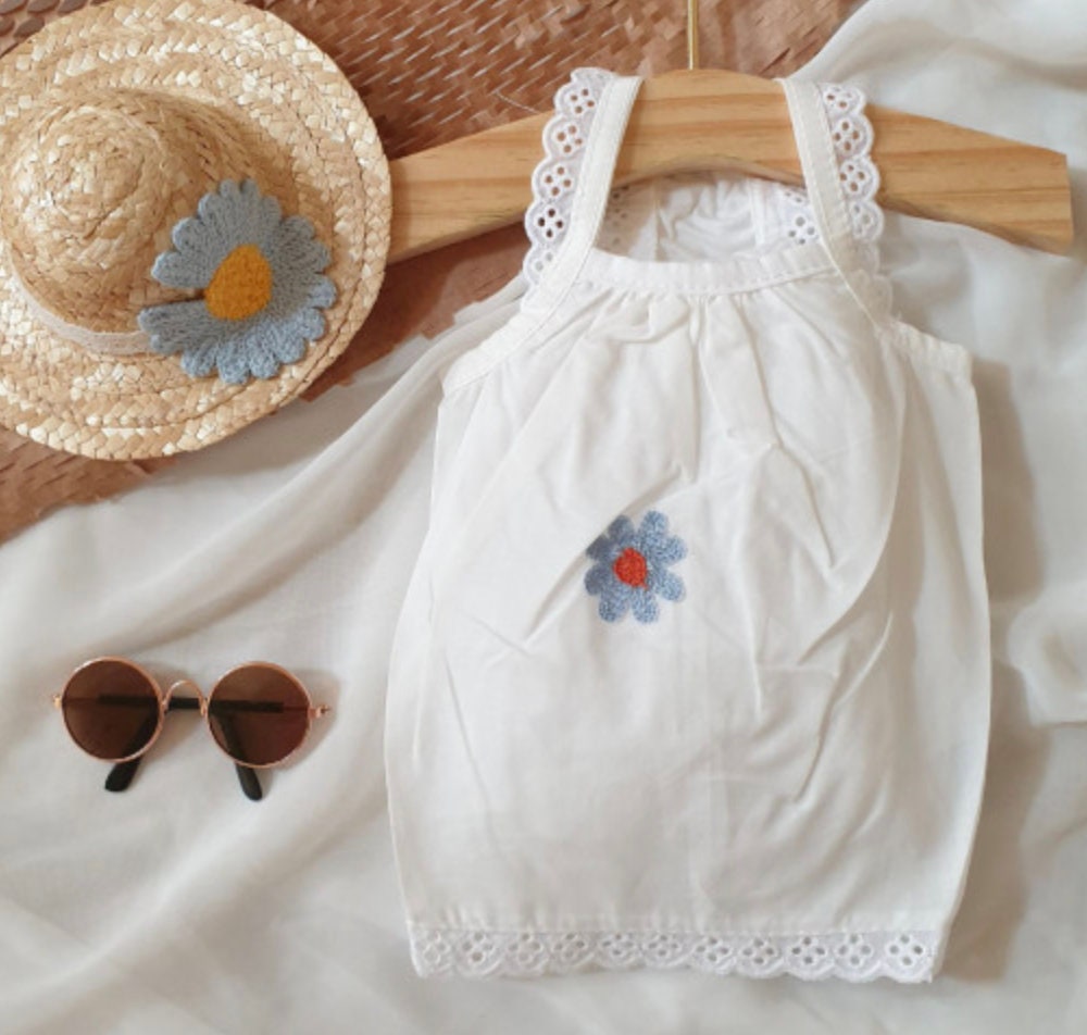 White NKpup cozy embroidered dog tank top with blue daisy detail and lace trim
