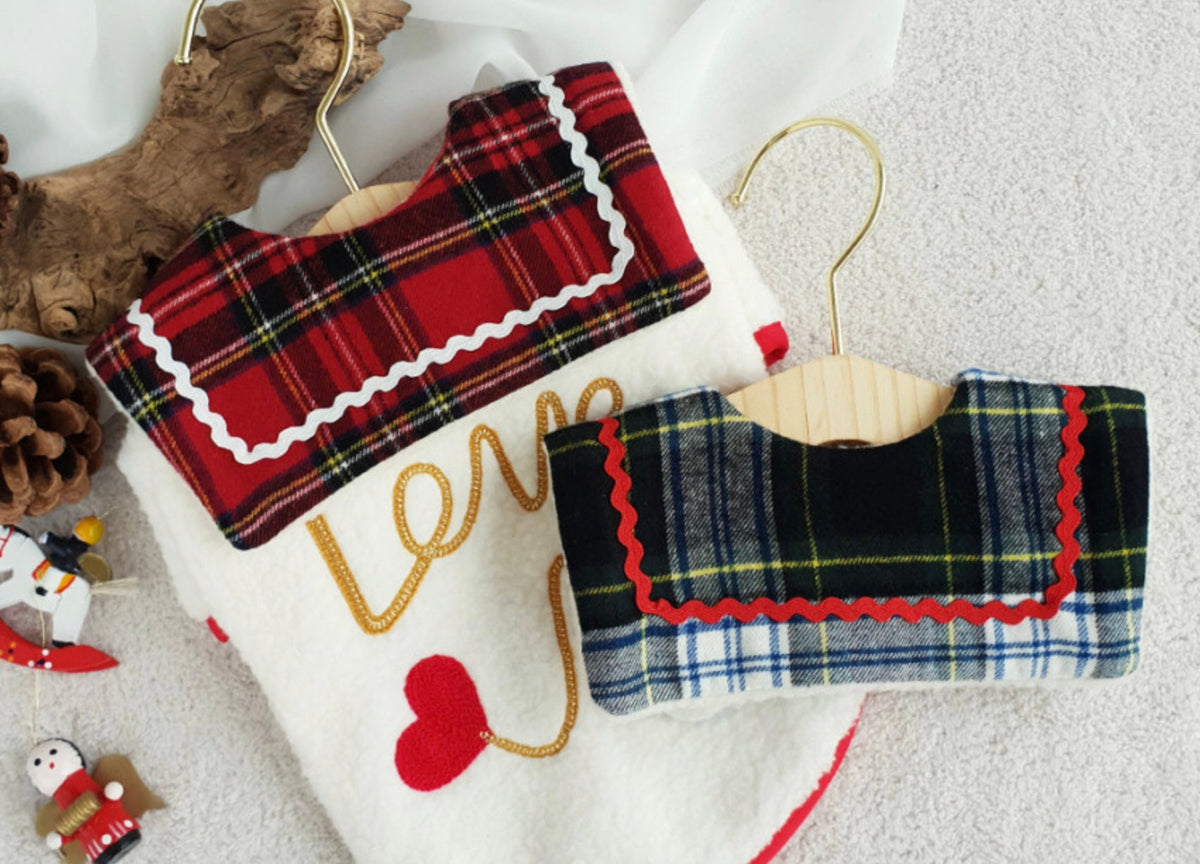 NKpup reversible plaid dog cape in red and blue check patterns with decorative scalloped trim.