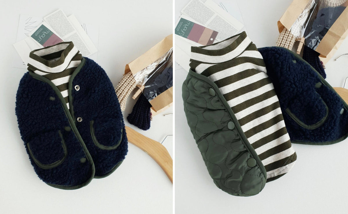 NKpup reversible bomber dog vest in navy sherpa fleece and olive green quilted fabric with striped shirt.