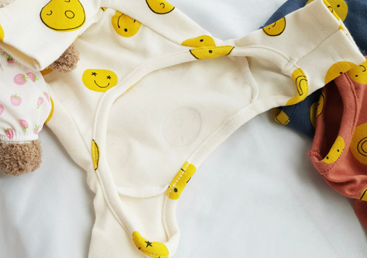 NKpup Smile Face Dog Overall in cream with yellow smiley face pattern