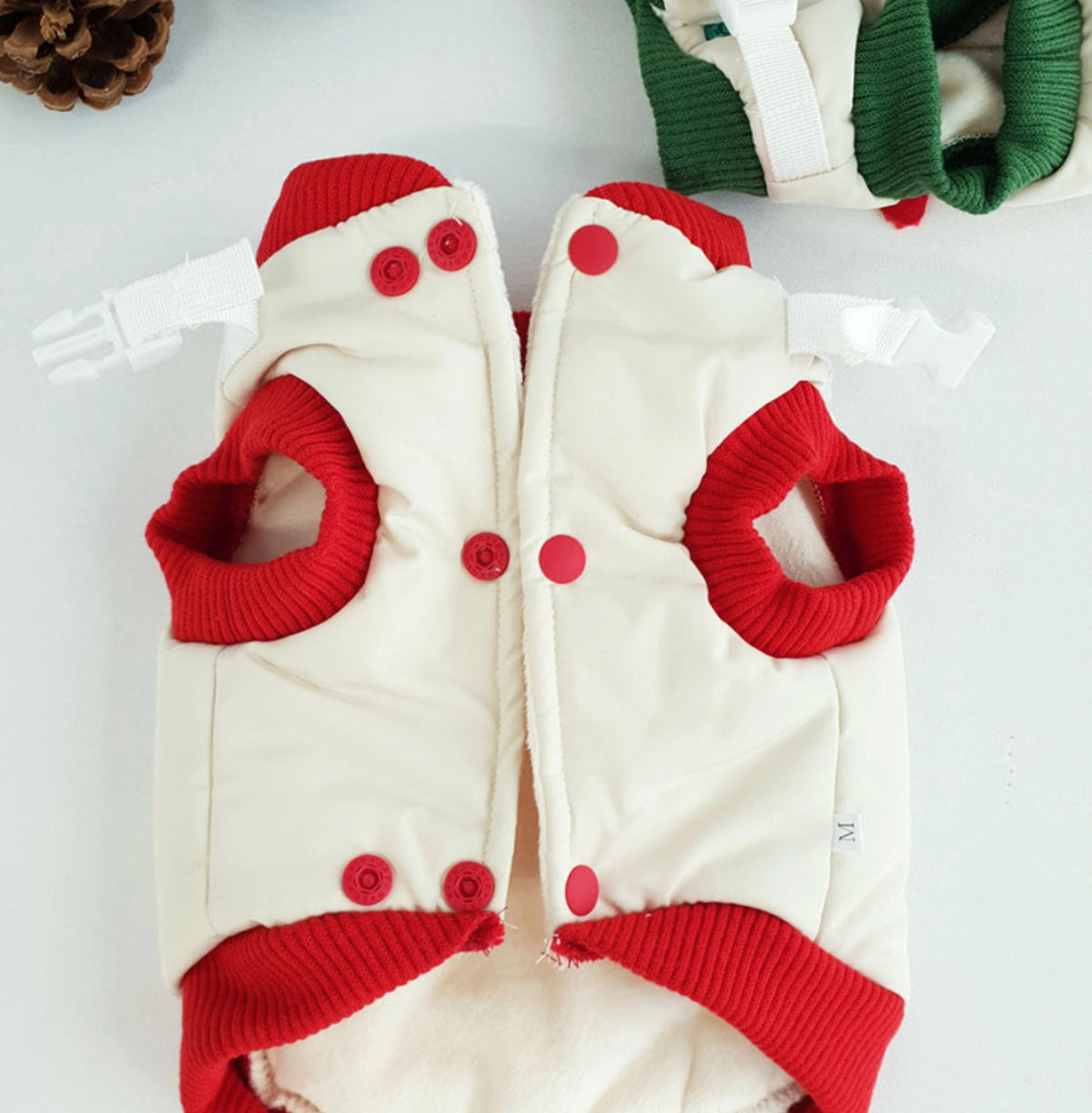 Christmas Rudolph padded dog vest in white and red with red trim and snap buttons.