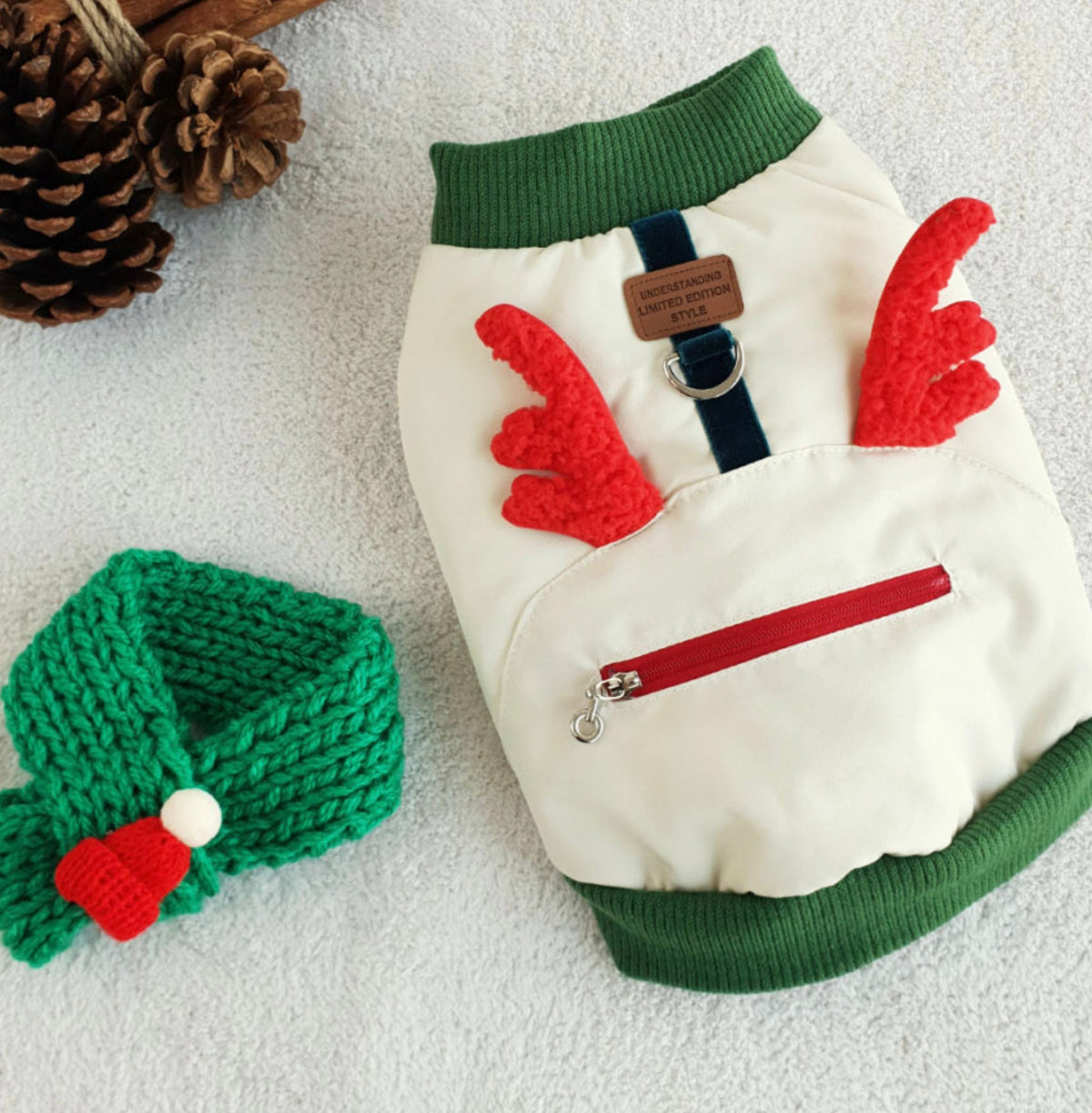 Christmas Rudolph padded dog vest in white and green with red reindeer antlers and a zipper pocket.