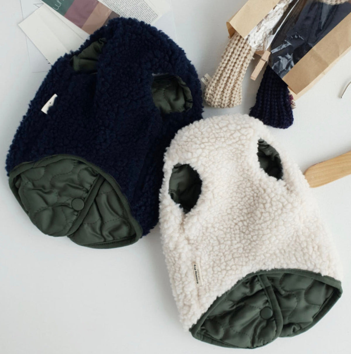 NKpup reversible bomber dog vests in navy blue sherpa and cream fleece with olive green quilted lining