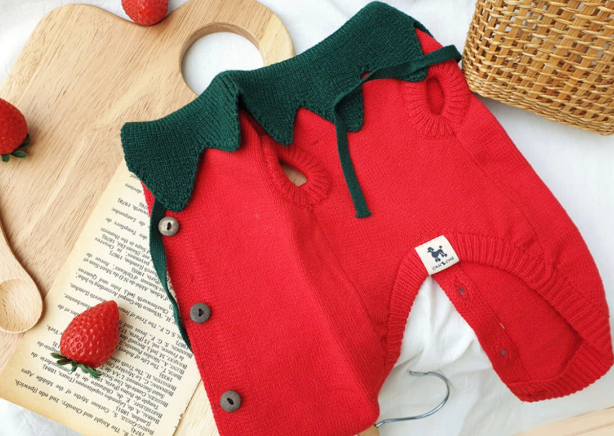 Red Halloween strawberry knit dog vest with green leaf collar detail