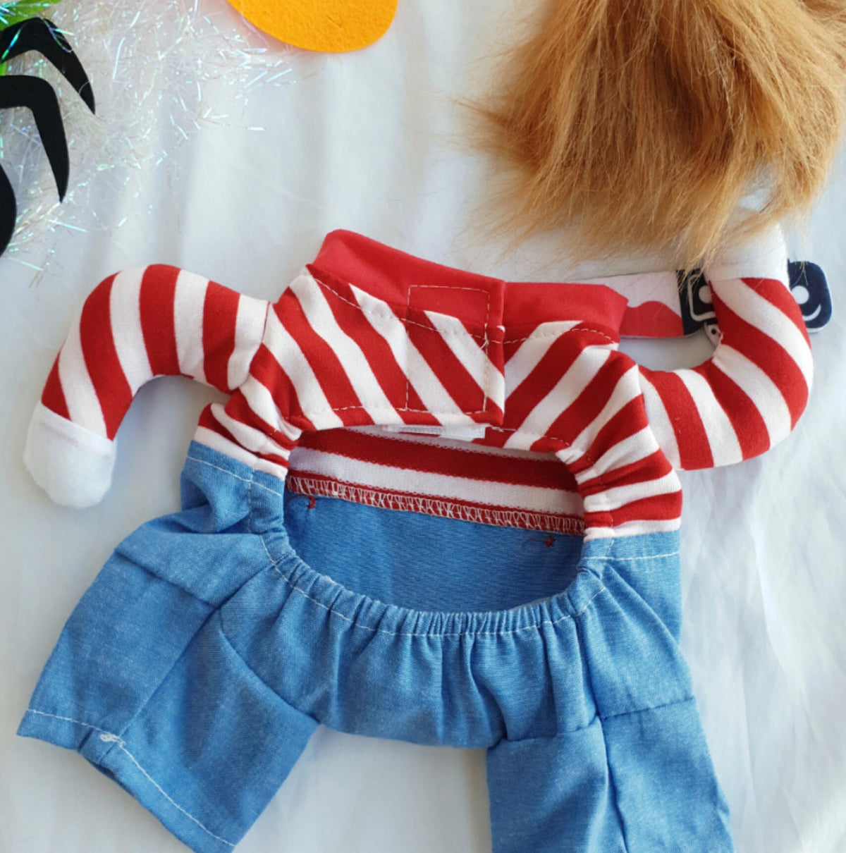 Chucky-themed Halloween dog costume featuring a red and white striped shirt and blue denim pants.