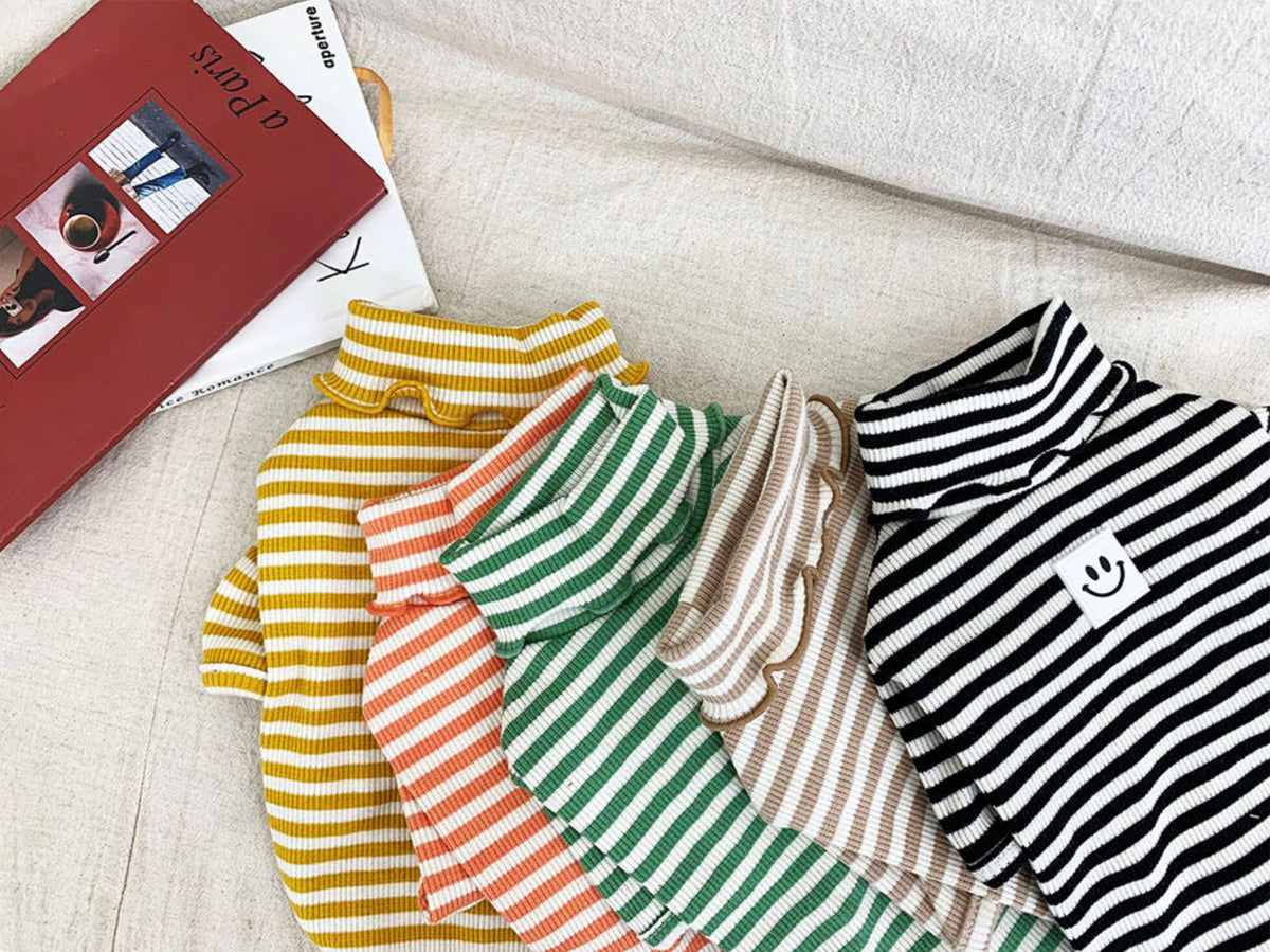 Collection of Willy Stripe Dog Turtleneck Shirts in yellow, orange, green, beige, and black stripes.