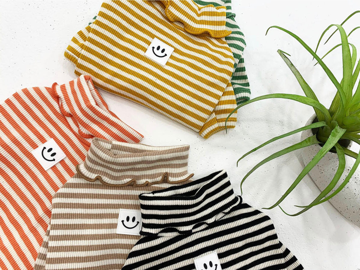 Assorted colors of Willy Stripe Dog Turtleneck Shirts featuring horizontal stripes and ruffle collars.