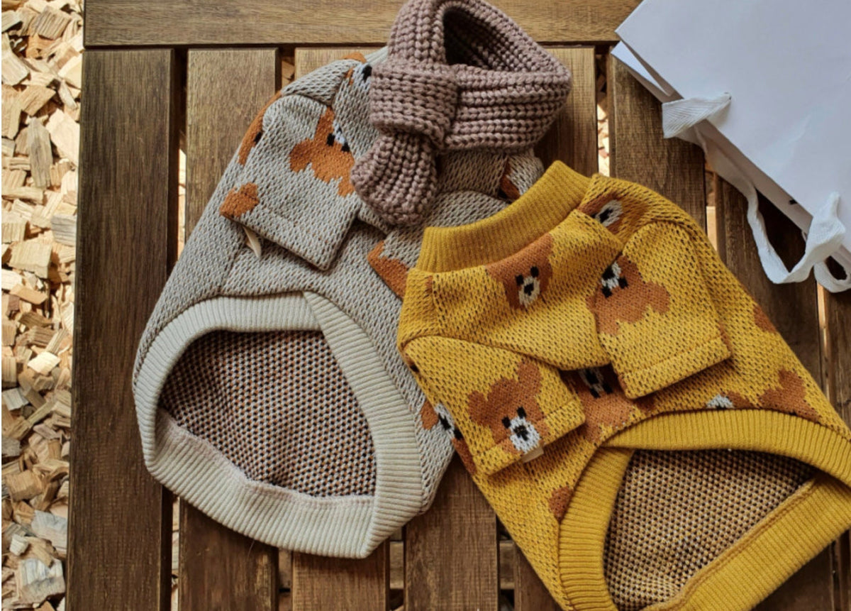 Two Bear Pixel dog knit sweaters in beige and mustard yellow.