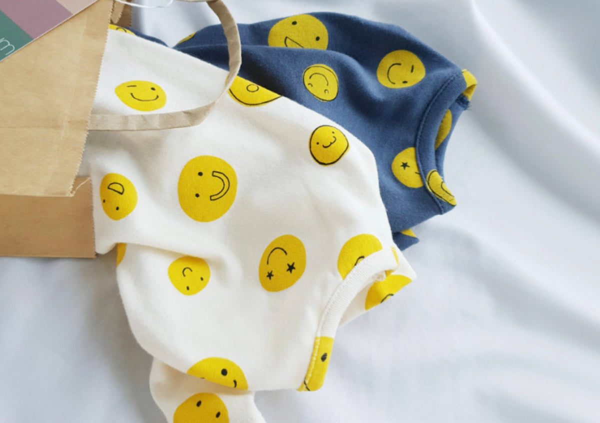 NKpup Smile Face Dog Overalls in white and navy blue with yellow smiley face patterns.