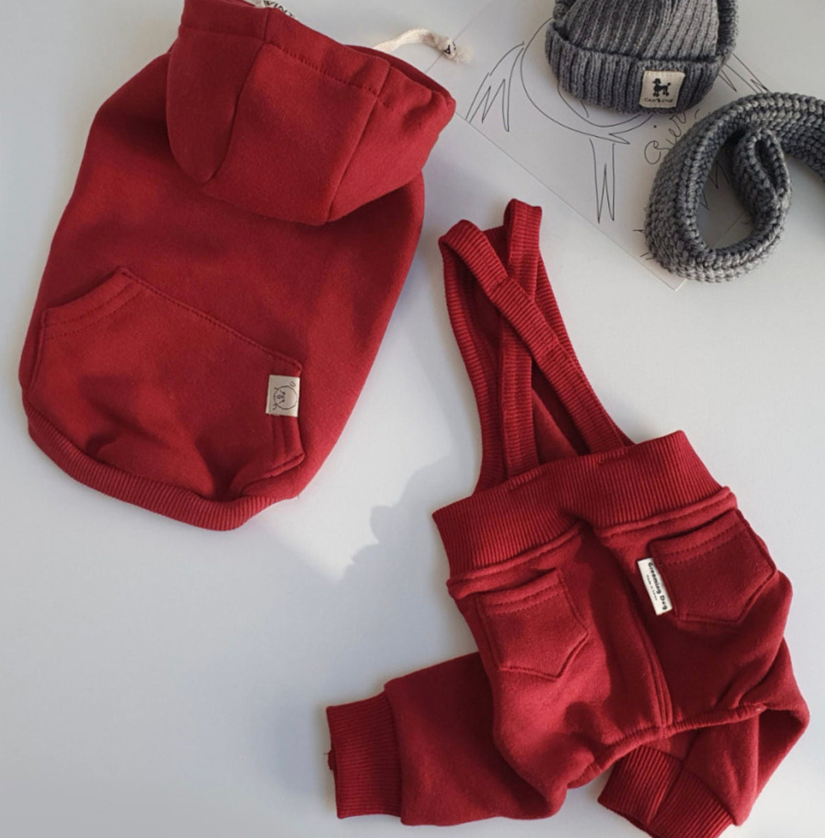 Red fleece dog suspender overalls and matching hooded dog sweatshirt.