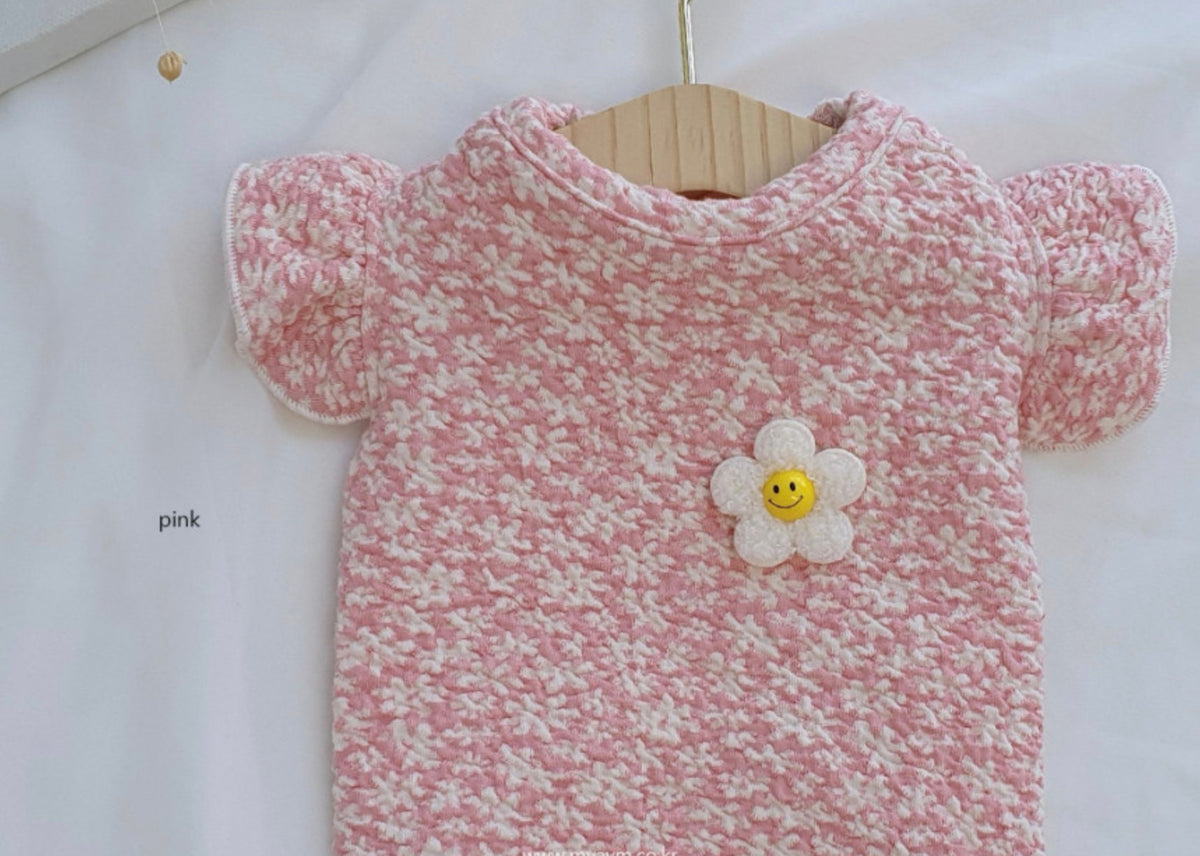 NKpup pink floral quilted sleeveless dog vest with a white smiley flower patch