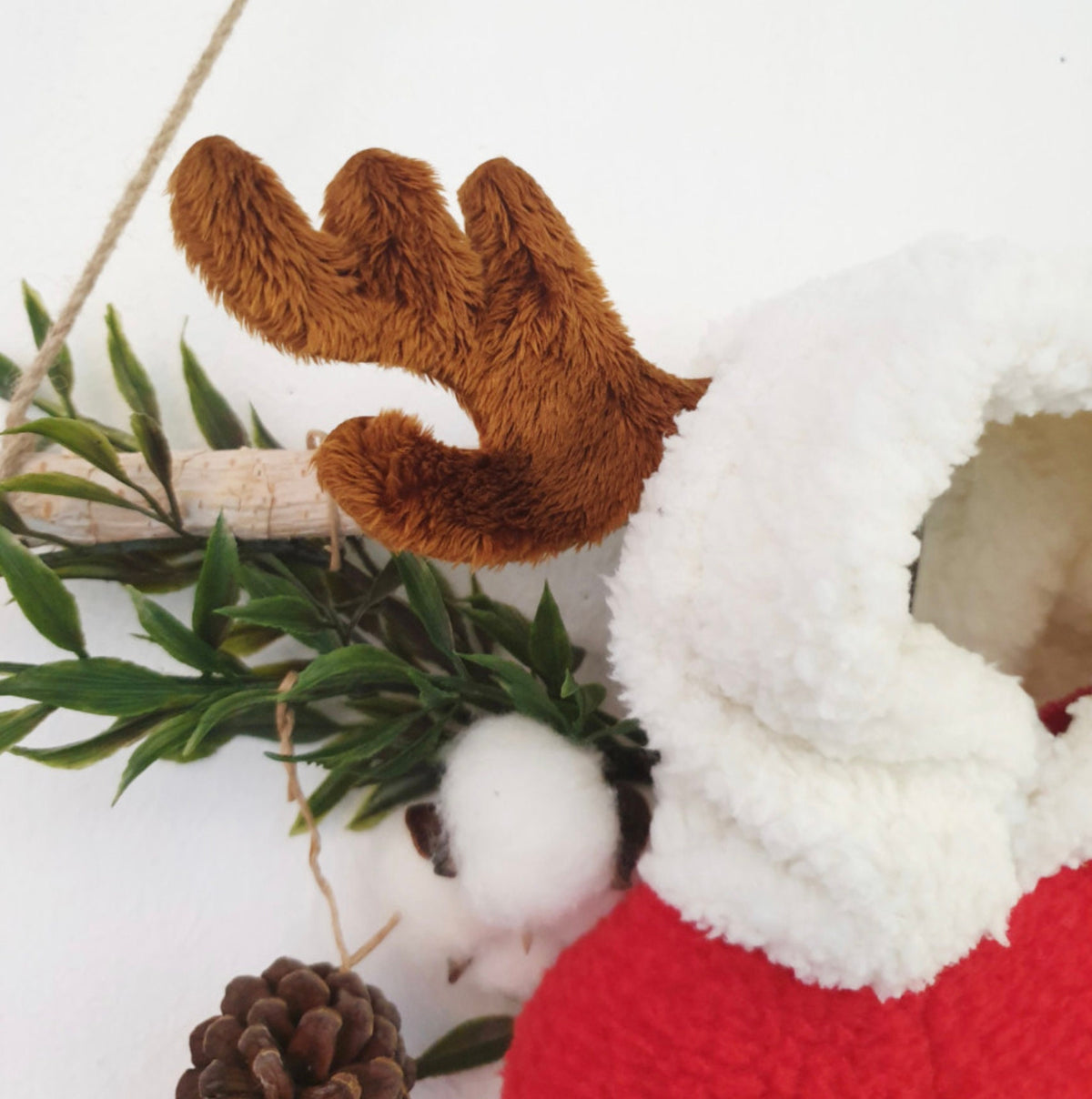 Close-up of NKpup red reindeer fleece dog hoodie with white faux fur trim and brown plush antlers