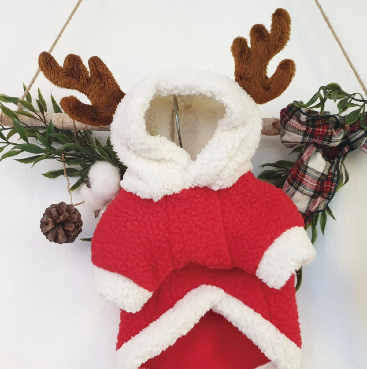 Red reindeer fleece dog hoodie with white faux fur trim and brown antlers