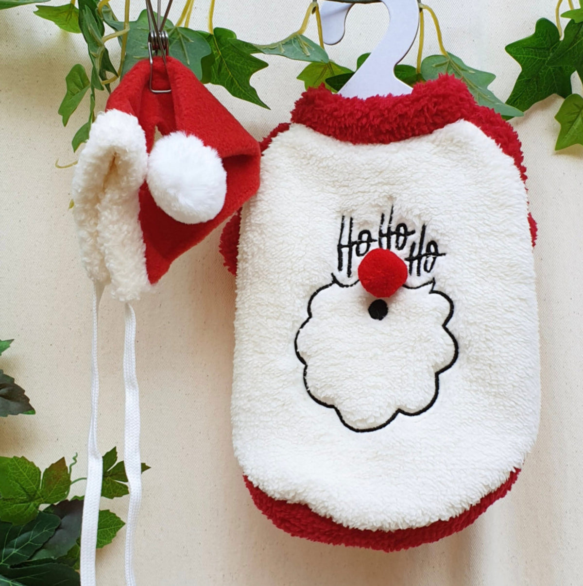 NKpup Santa face fleece dog shirt and matching red Santa hat with white trim.