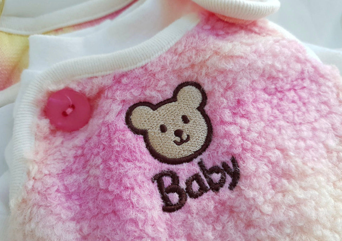 Close-up of NKpup Aurora Boa Fleece Dog Vest in pink with a bear embroidery and 'Baby' text.