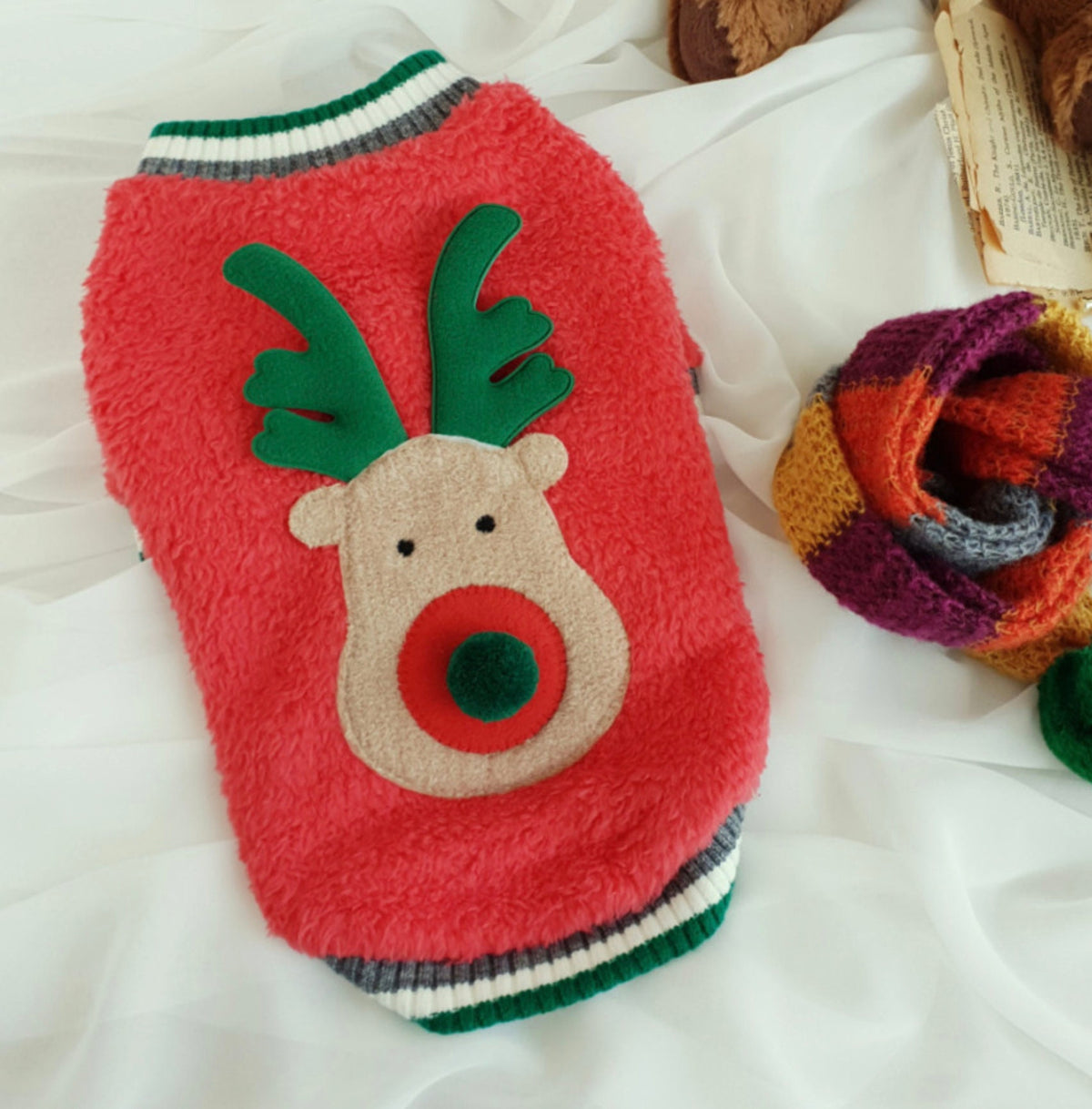 Red Rudolph fleece dog sweatshirt with green antlers and a tan reindeer face design.