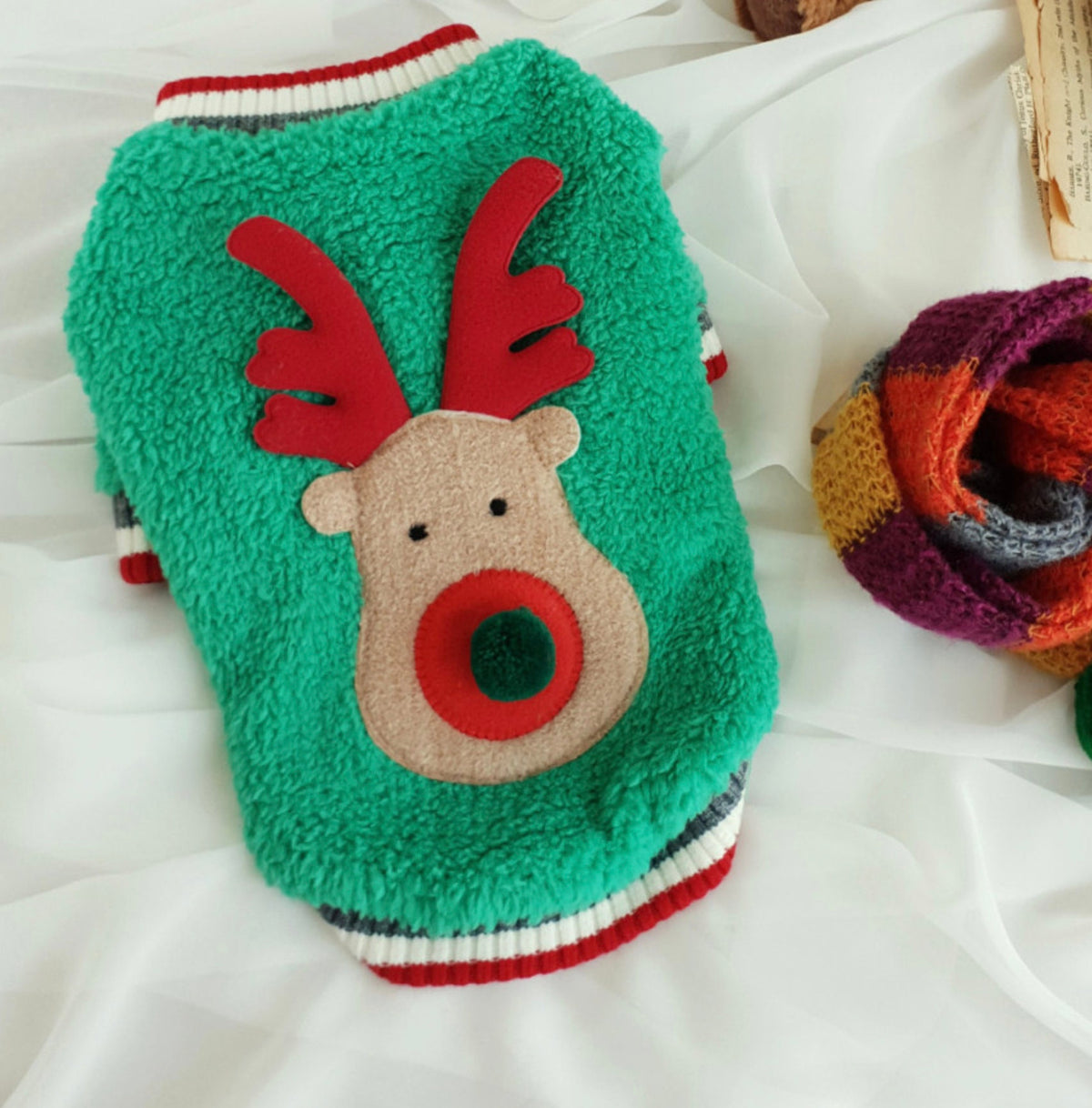 Green Rudolph fleece dog sweatshirt with red antlers and a red nose design.